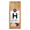Eine braune Papiertüte mit 500 g Antersdorfer Mühle Porridge Hafer-Saaten, auf deren Etikett eine Schüssel mit Porridge und Beeren abgebildet ist.