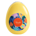 Die Pralinenmischung in Osterei Dose von Venchi (77 g) hat eine gelbe, eiförmige Dose mit buntem Blumenmuster und einem runden Venchi-Etikett in der Mitte.