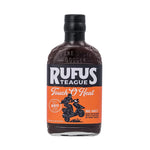 Abgebildet ist eine 432-g-Flasche Rufus Teague Touch O Heat Sauce mit einem schwarz-orangenen Etikett auf weißem Hintergrund.
